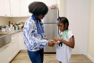 Courtney Bailey, 28, mother of five children, serves lunch to daughter NoelleMorris, 7, at their apartment 