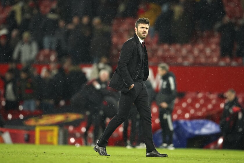 Manchester United's temporary coach Michael Carrick walks off the pitch at the end of the English Premier League soccer match between Manchester United and Arsenal at Old Trafford stadium in Manchester, England, Thursday, Dec. 2, 2021. United won the match 3-2. (AP Photo/Dave Thompson)
