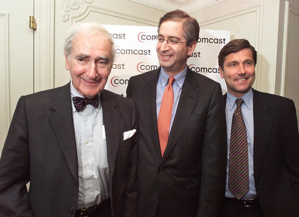 Comcast Chairman Ralph Roberts, left, President Brian Roberts, center, and Steve Burke, president of Comcast Cable, in 2001 after Comcast offered to buy AT&T Broadband.