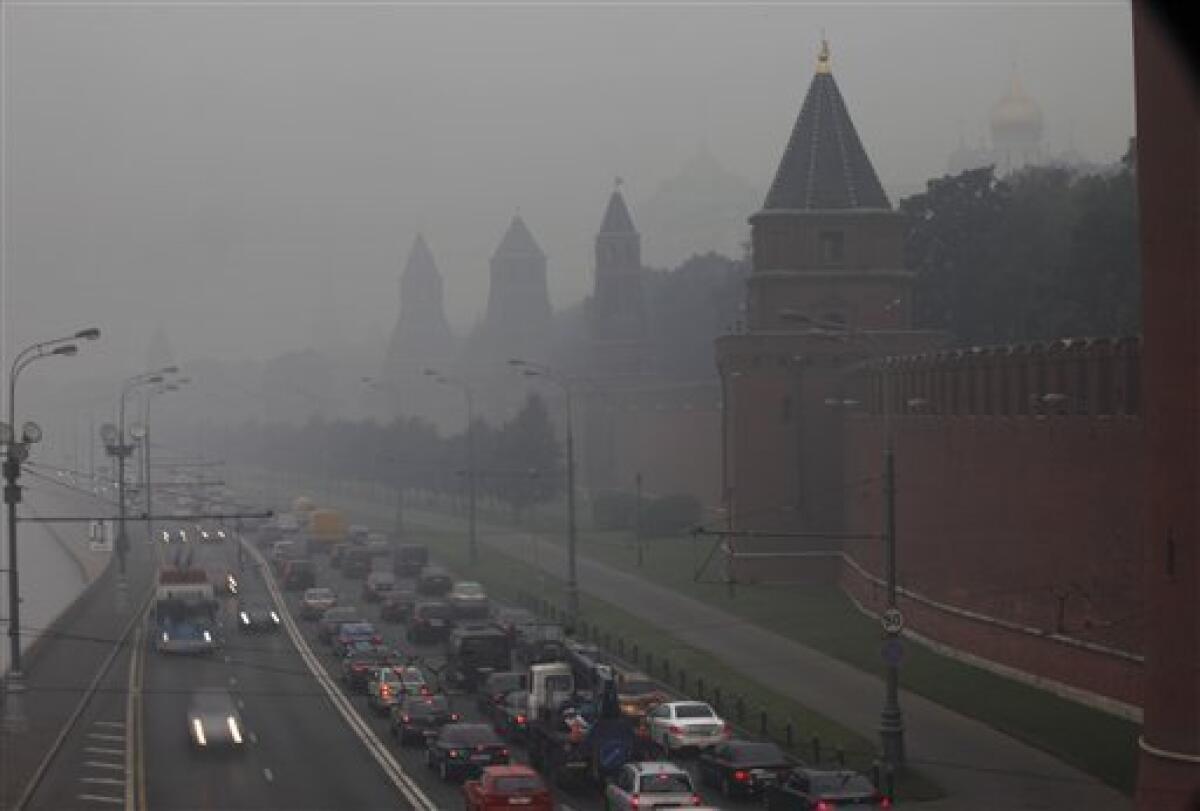 An embankment of the Moskva River near the Kremlin, right, is seen trough the thickest blanket of smog covering Moscow, Russia, early Friday, Aug. 6, 2010. Temperatures up to 100 F (38 C) have exacerbated forest and peat bog fires across Russia's central and western regions, destroying close to 2,000 homes. (AP Photo/Alexander Zemlianichenko)
