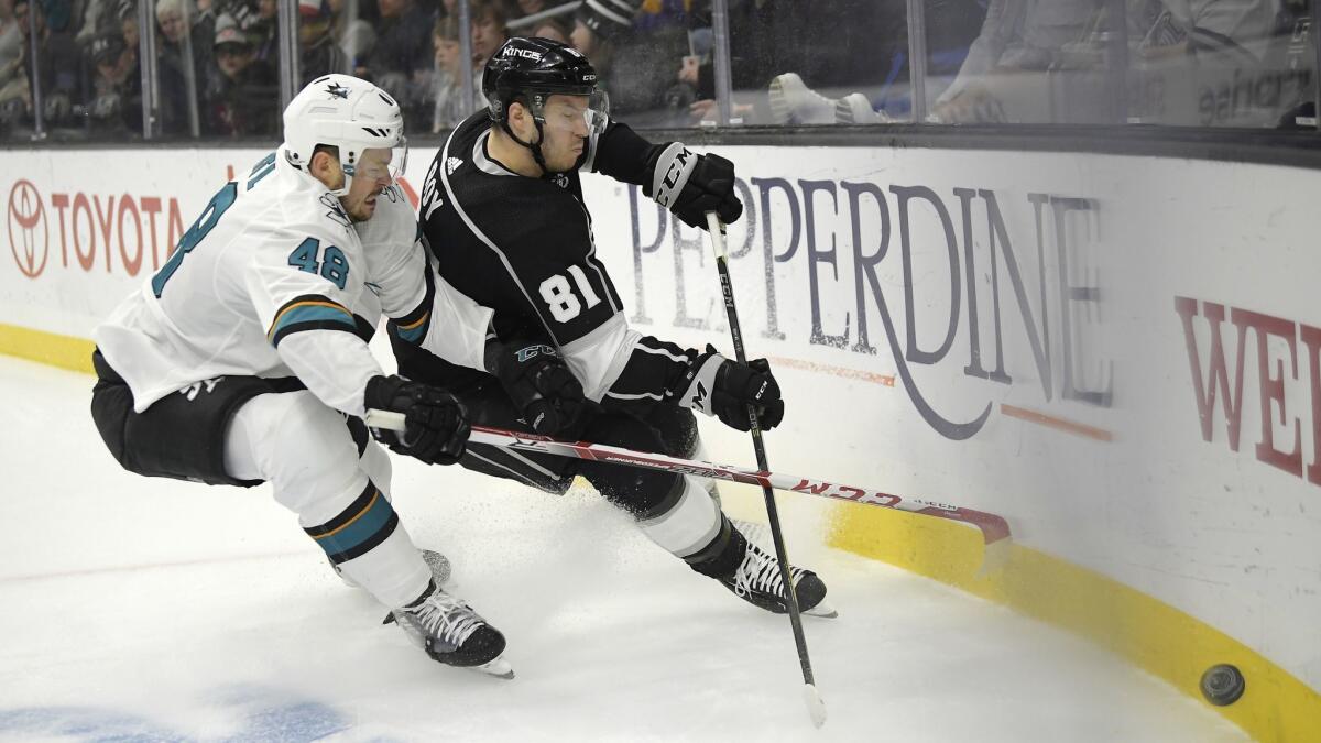 San Jose Sharks center Tomas Hertl, left, and Kings defenseman Matt Roy race to the puck during the first period of the Kings' 4-2 win Thursday.