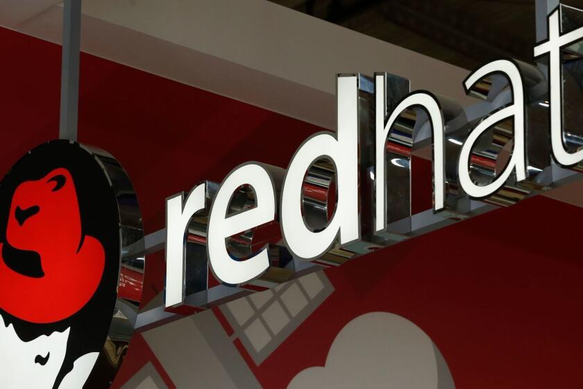 (FILES) In this file photo taken on February 26, 2018 The logo of Red Hat Software is pictured at the Mobile World Congress (MWC), the world's biggest mobile fairin Barcelona. - IBM said on October 28, 2018 it has reached a deal to buy software company Red Hat for USD 34 billion, a move the computing giant said would enhance its cloud offerings, a key area of growth. (Photo by Pau Barrena / AFP)PAU BARRENA/AFP/Getty Images ** OUTS - ELSENT, FPG, CM - OUTS * NM, PH, VA if sourced by CT, LA or MoD **