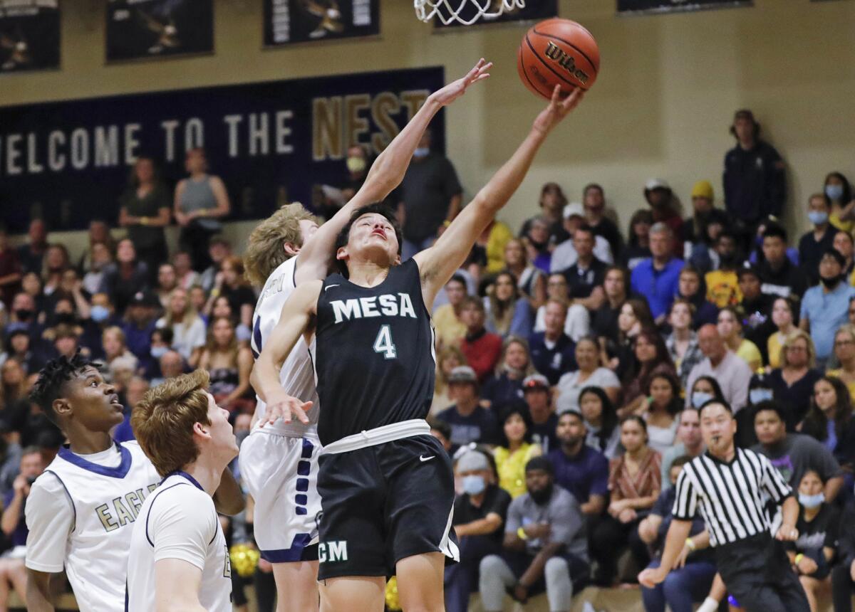 Nathan Schipper (4) extends for a layup past the defense of Calvary Chapel's Tyler Peterson in the CIF Division 5AA final.