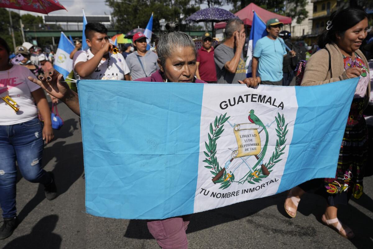 Market vendors march toward downtown during a national strike in Guatemala City