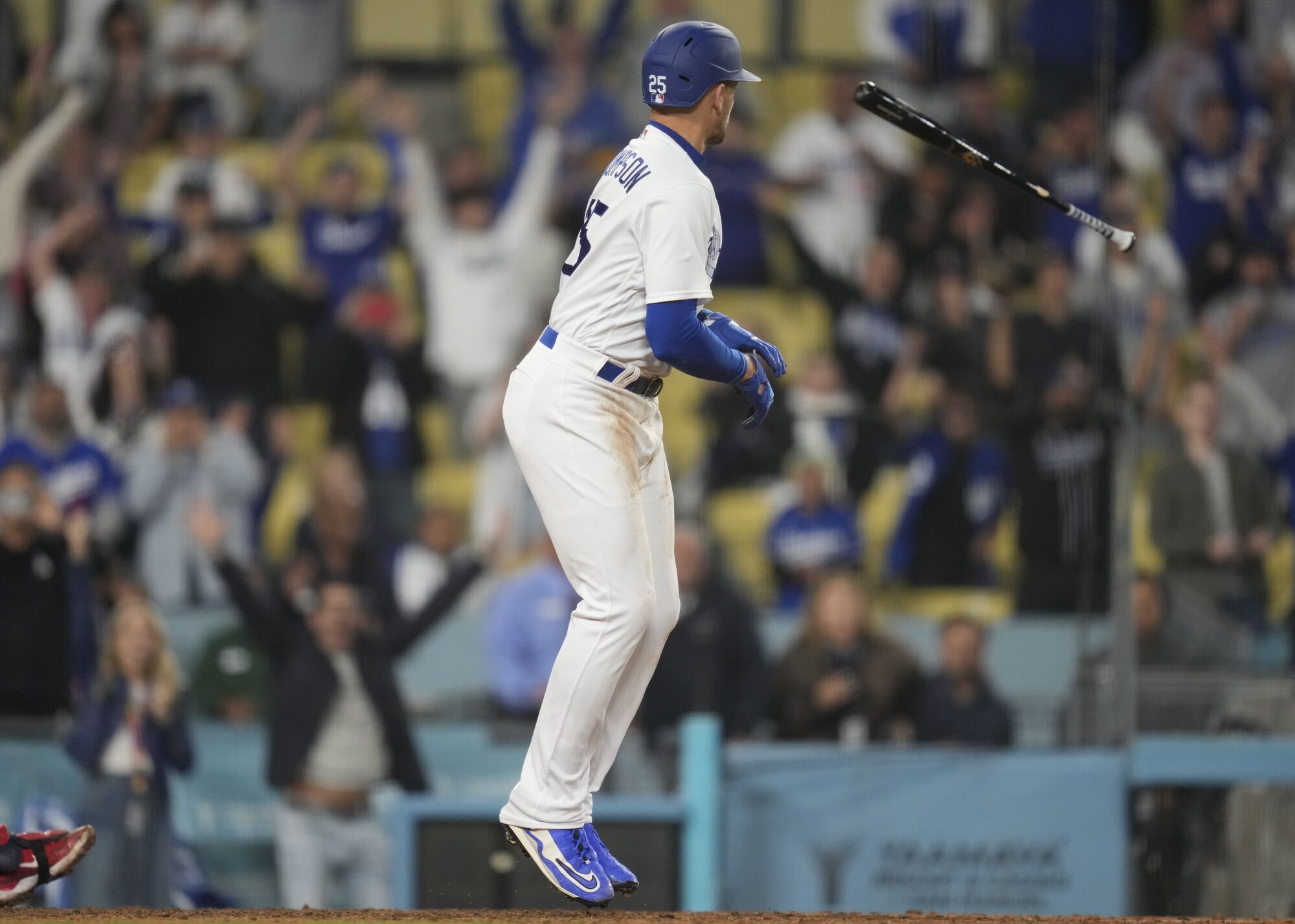 Trayce Thompson tosses his bat after drawing a walk-off walk during the 12th inning of a game against the Minnesota Twins 