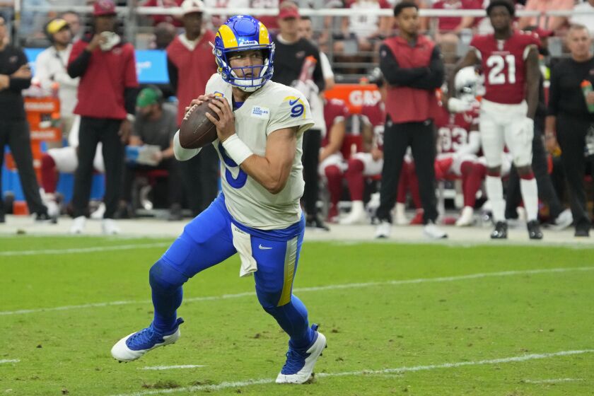 Los Angeles Rams quarterback Matthew Stafford (9) looks to pass against the Arizona Cardinals during the second half of an NFL football game, Sunday, Sept. 25, 2022, in Glendale, Ariz. (AP Photo/Rick Scuteri)
