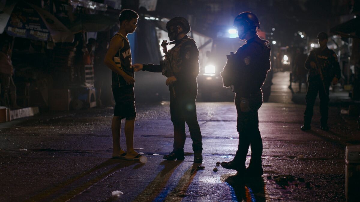 Late night interrogation of residents suspected of drug dealing in Caloocan, Manila, by police in the documentary "On the President's Orders."