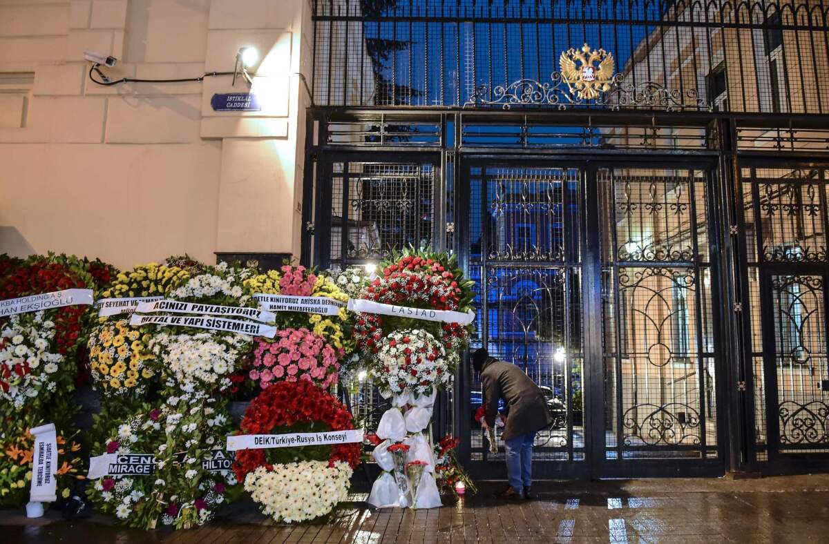 A man lays flowers outside the Russian Consulate in Istanbul on Dec. 20, 2016, in tribute to the Russian ambassador who was assassinated the day before in the Turkish capital.