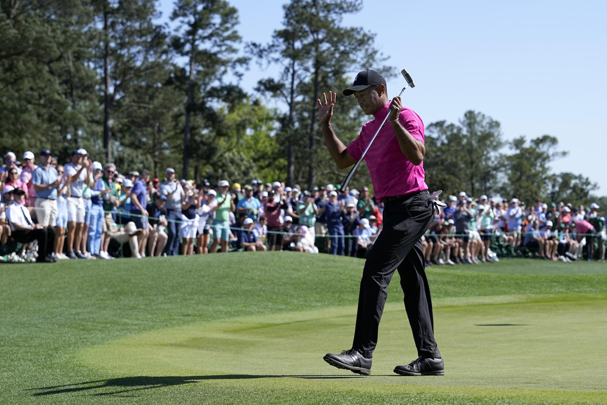 Tiger Woods acknowledges applause on the 18th green.