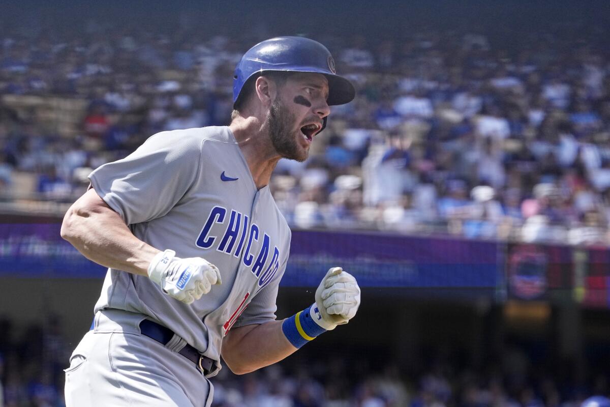 Patrick Wisdom celebrates after hitting a home run for the Cubs in the sixth inning Sunday.