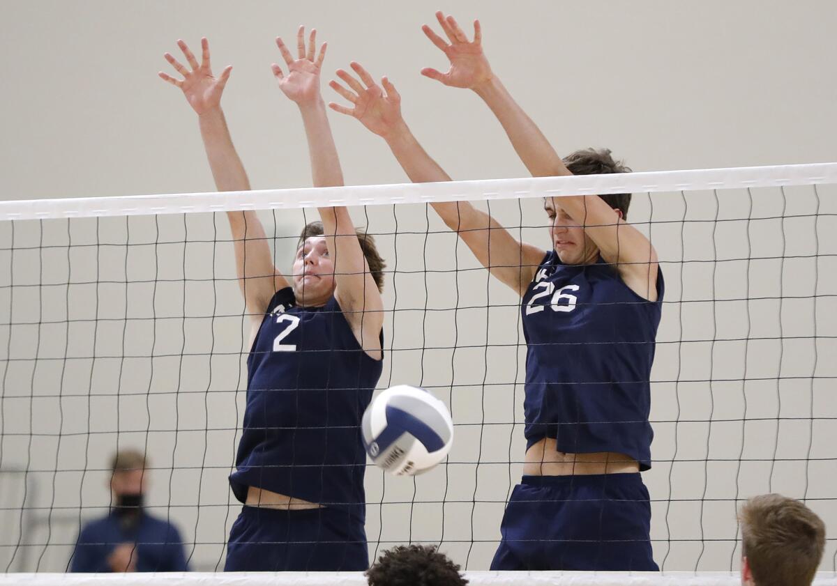 Cole McKibbin (2) and James Eadie (26) block a kill by a Mira Costa outside hitter during the CIF Division 1 final.