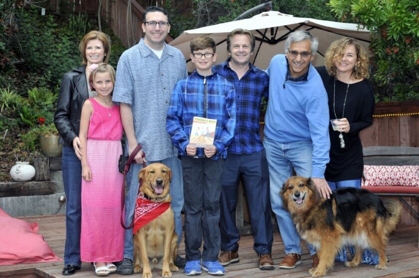 Pancho (left) with new family Jen, Allie, Steve and Jake Hamilton, author Tom Fremantle, hosts Richard and Monica Kiy, Pancho's friend Bindi (right). Photo by McKenzie Images
