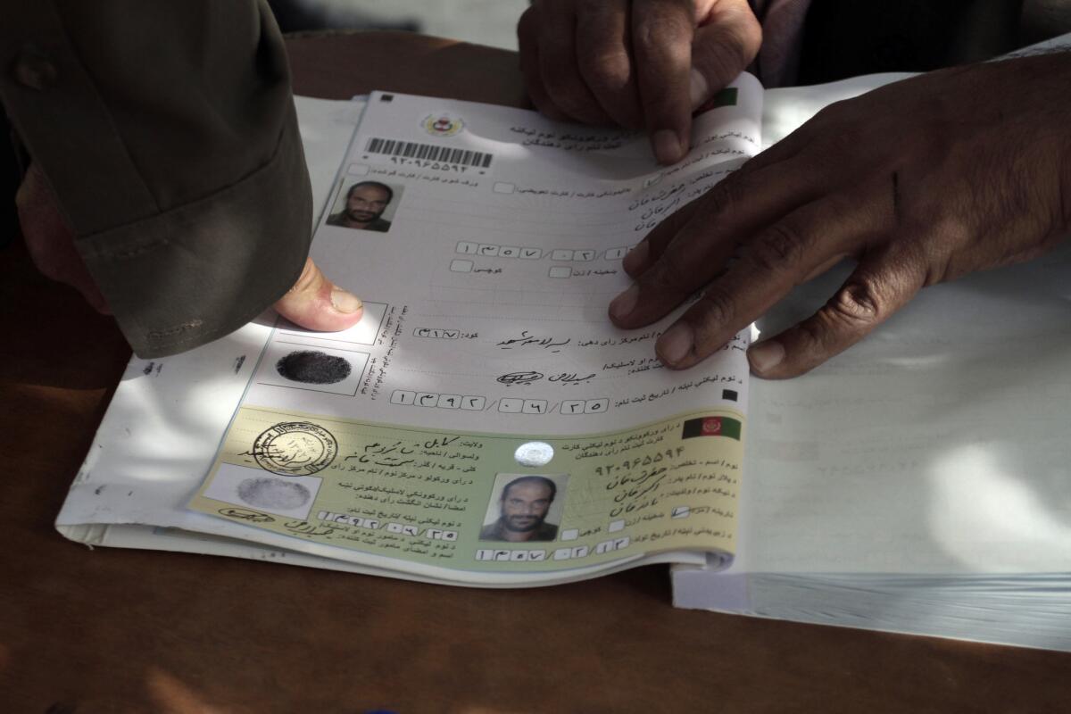 An Afghan man marks his voter registration application with his fingerprint in Kabul.