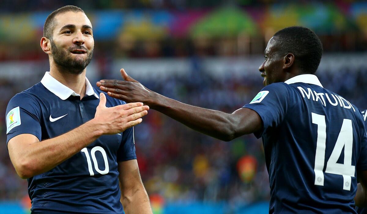 France forward Karim Benzema (10) celebrates with teammate Blaise Matuidi after scoring his team's final goal in a 3-0 victory over Honduras on Sunday in a World Cup Group E game at Estadio Beira-Rio in Porto Alegre, Brazil.