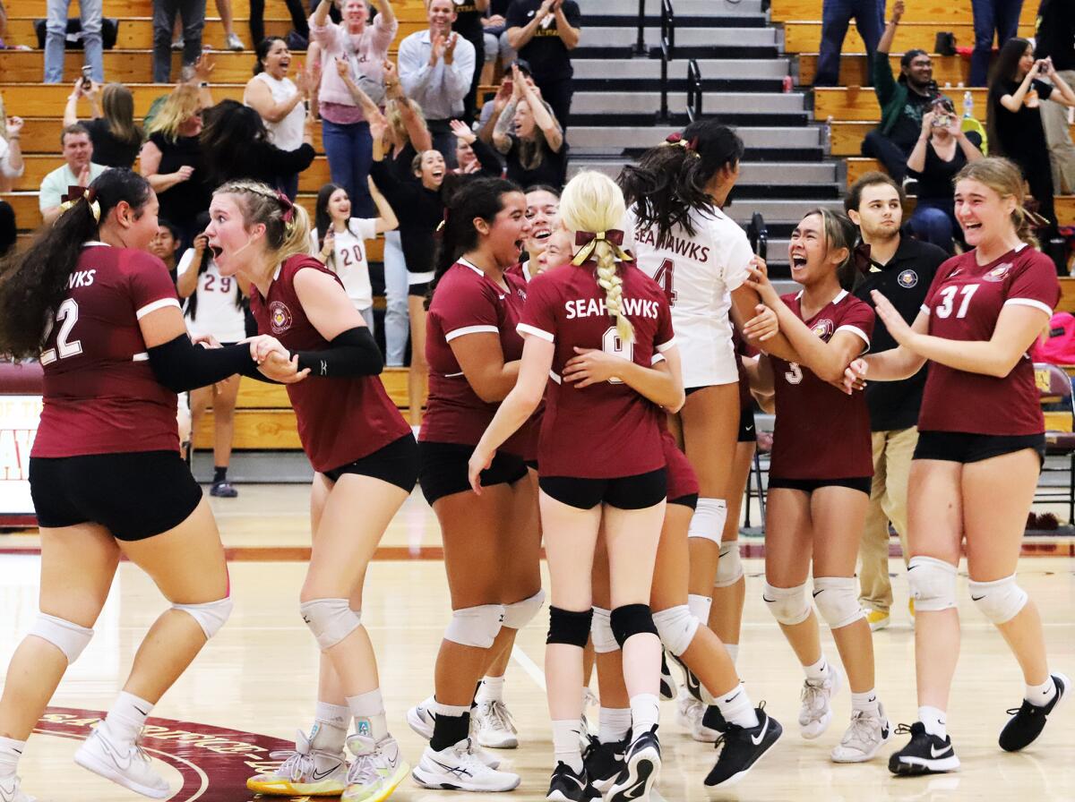 The Ocean View girls' volleyball team celebrates after beating Westminster for the Golden West League title on Wednesday.