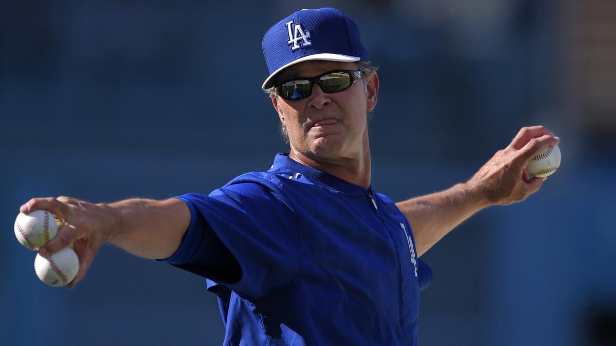 Dodgers Manager Don Mattingly throws during batting practice before a game against the San Francisco Giants on April 29, 2015.