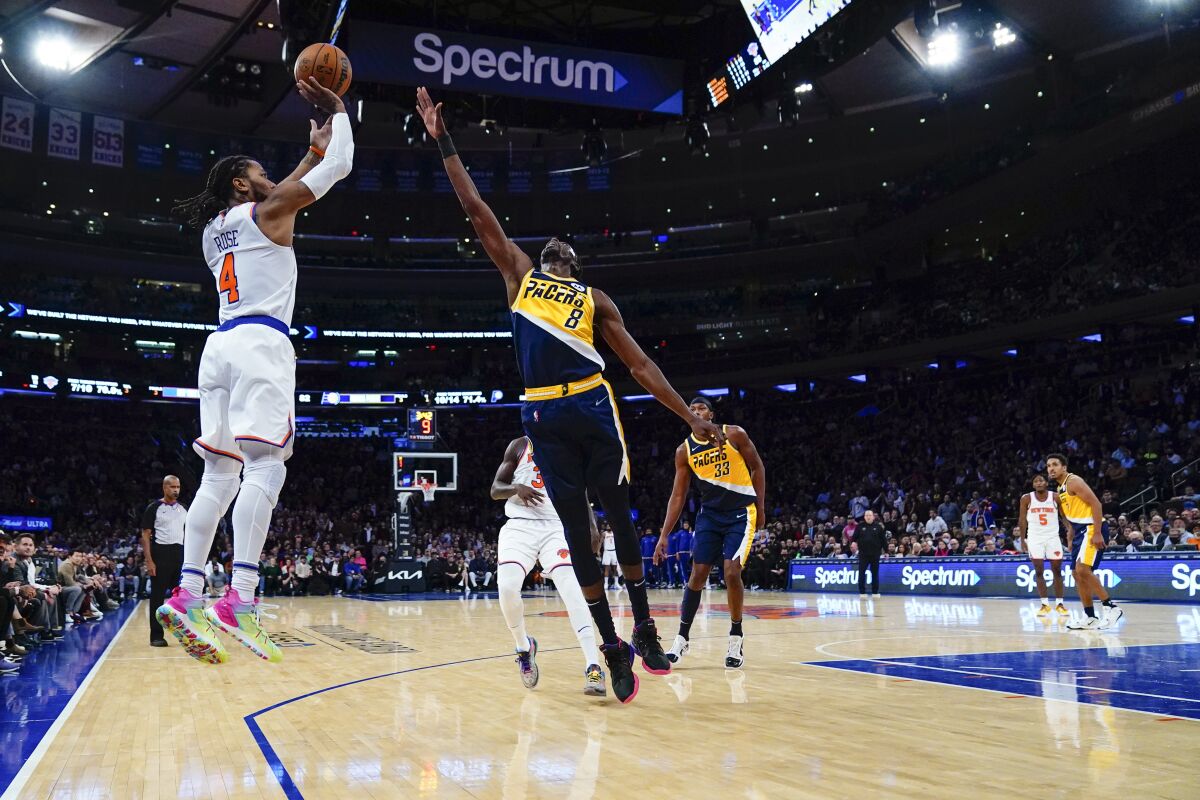 New York Knicks' Derrick Rose (4) shoots over Indiana Pacers' Justin Holiday (8) during the second half of an NBA basketball game Monday, Nov. 15, 2021, in New York. The Knicks won 92-84.(AP Photo/Frank Franklin II)