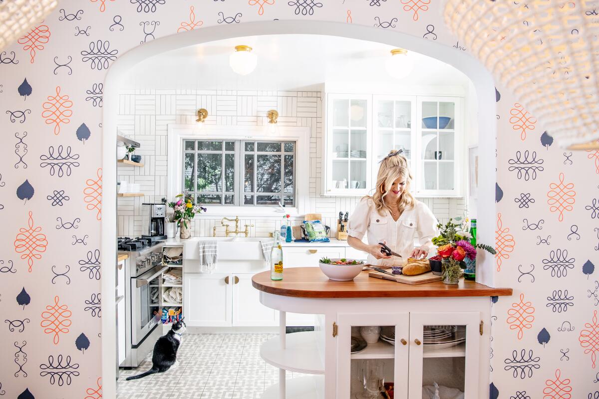 Arden Myrin's kitchen is complemented by hand-printed wallpaper by Juju Papers.