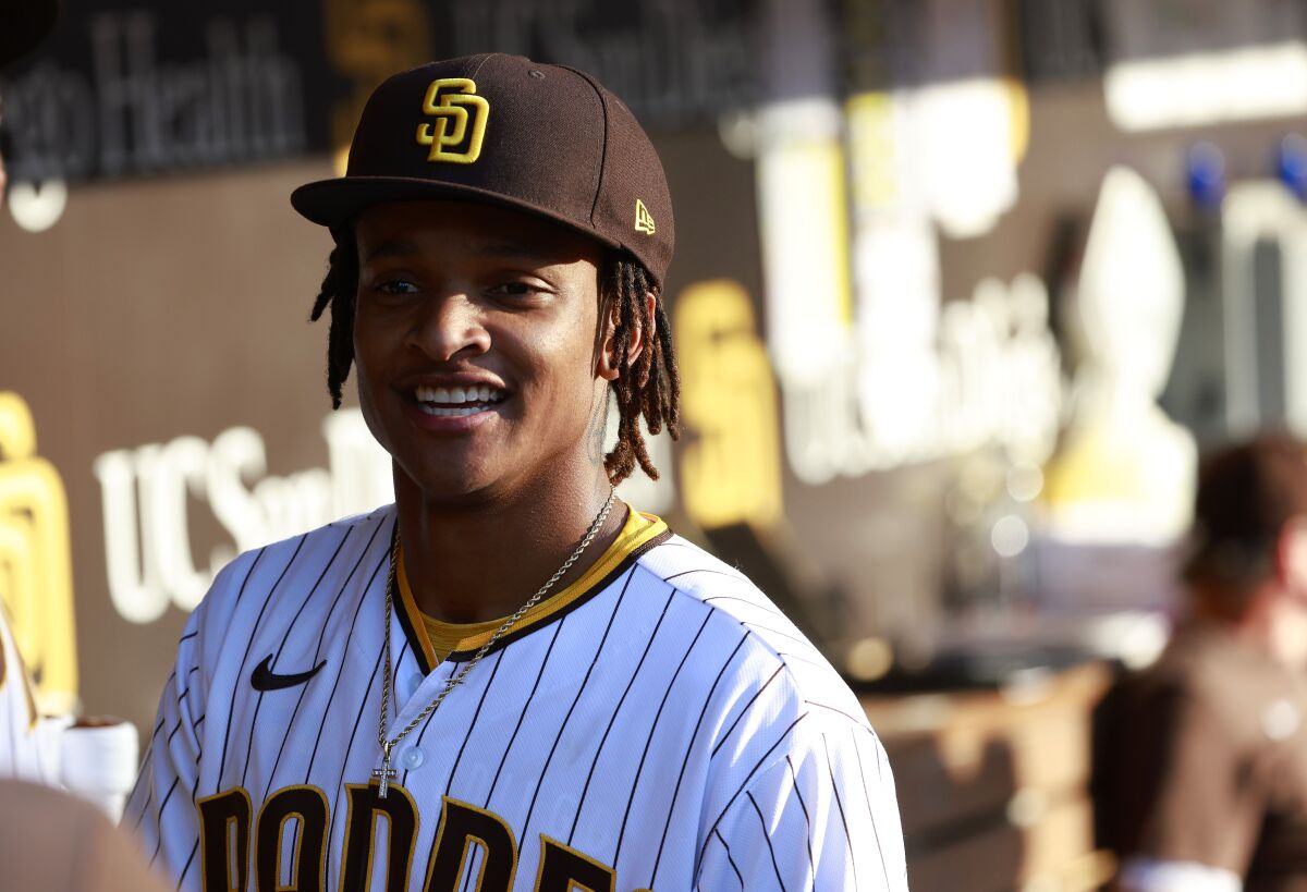 The Padres' CJ Abrams smiles in the dugout 