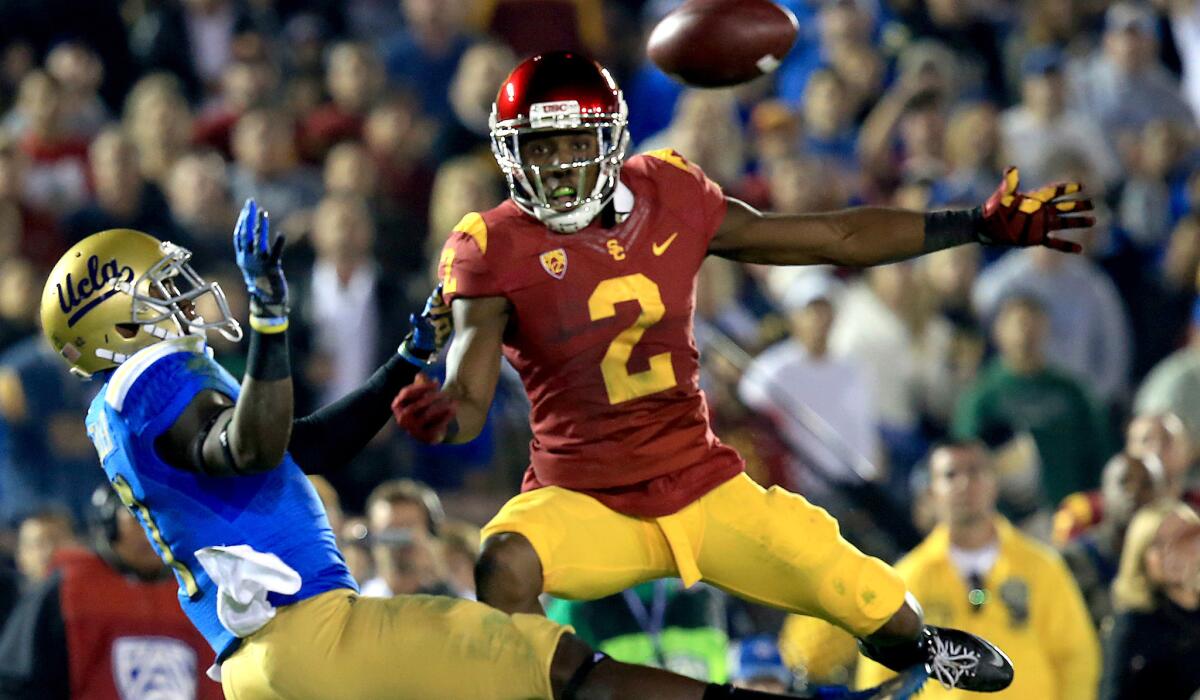 USC cornerback Adoree' Jackson breaks up a pass play intended for UCLA receiver Devin Fuller during their annual rivalry game on Nov. 22, 2014.