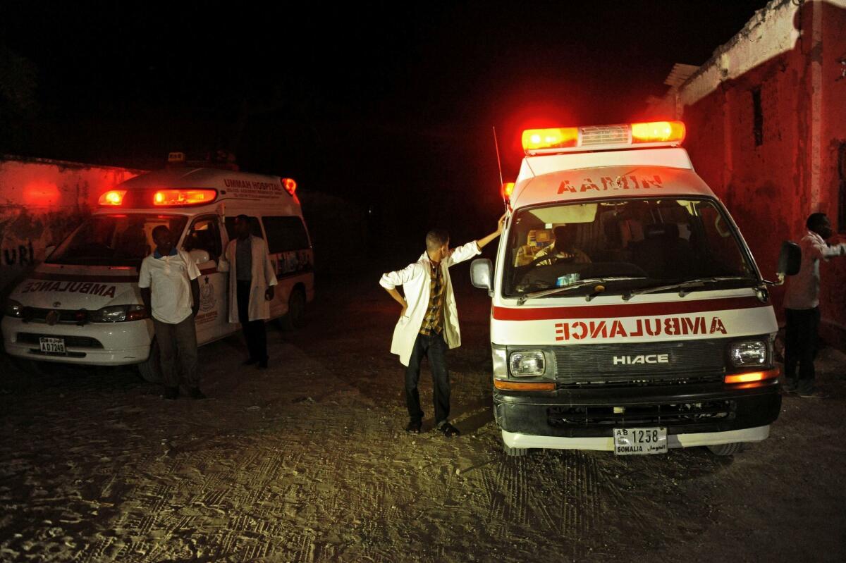 Two ambulances stand near the scene of an armed attack on a restaurant in Mogadishu, Somalia, on Jan. 21.