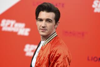 Drake Bell poses at a movie premiere