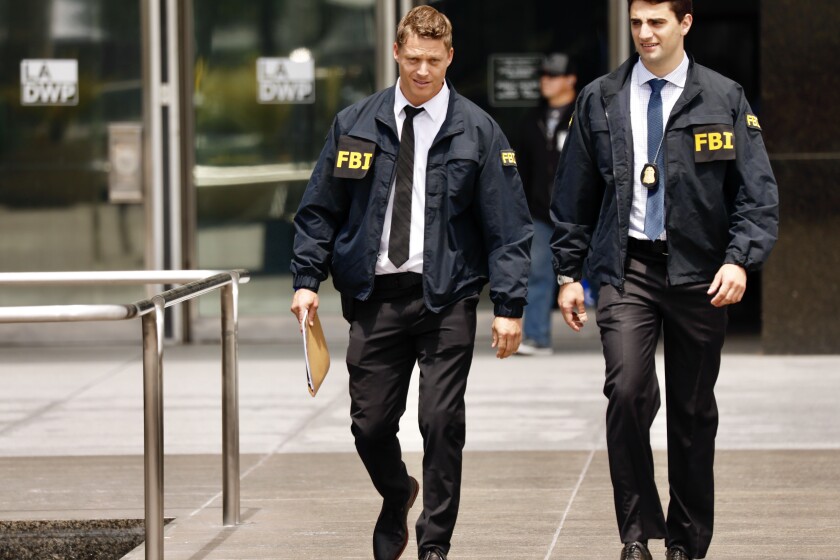 LOS ANGELES CA JULY 22, 2019 -- FBI agents leave the downtown headquarters of the Los Angeles Department of Water and Power after serving a search warrant Monday, July 22, 2019. Authorities have declined to discuss the nature of the investigation. (Al Seib / Los Angeles Times)
