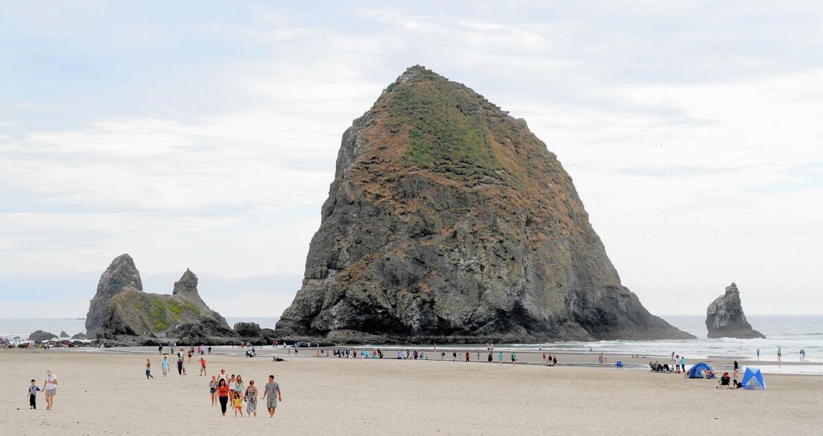 The 235-feet-tall Haystack Rock is a federally protected area with tide pools and nesting sites in Cannon Beach, Ore.