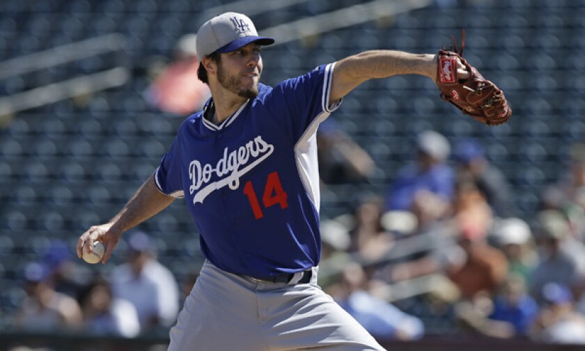 Dodgers starter Dan Haren delivers a pitch during a Cactus League game against the Kansas City Royals on March 11. Haren struggled in a practice game in Arizona on Monday.