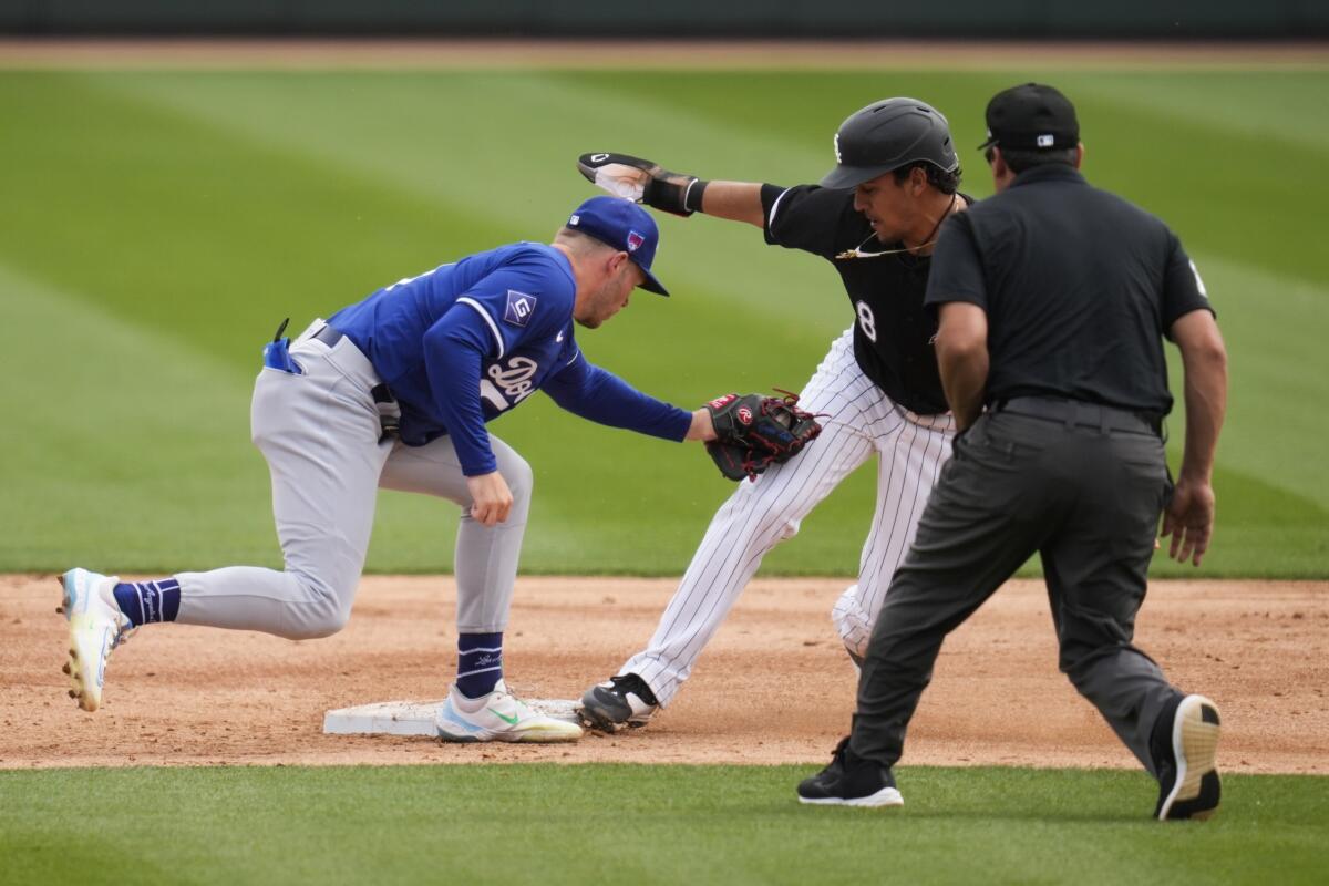 The White Sox's Nicky Lopez steals second base ahead of a throw to Dodgers shortstop Gavin Lux.