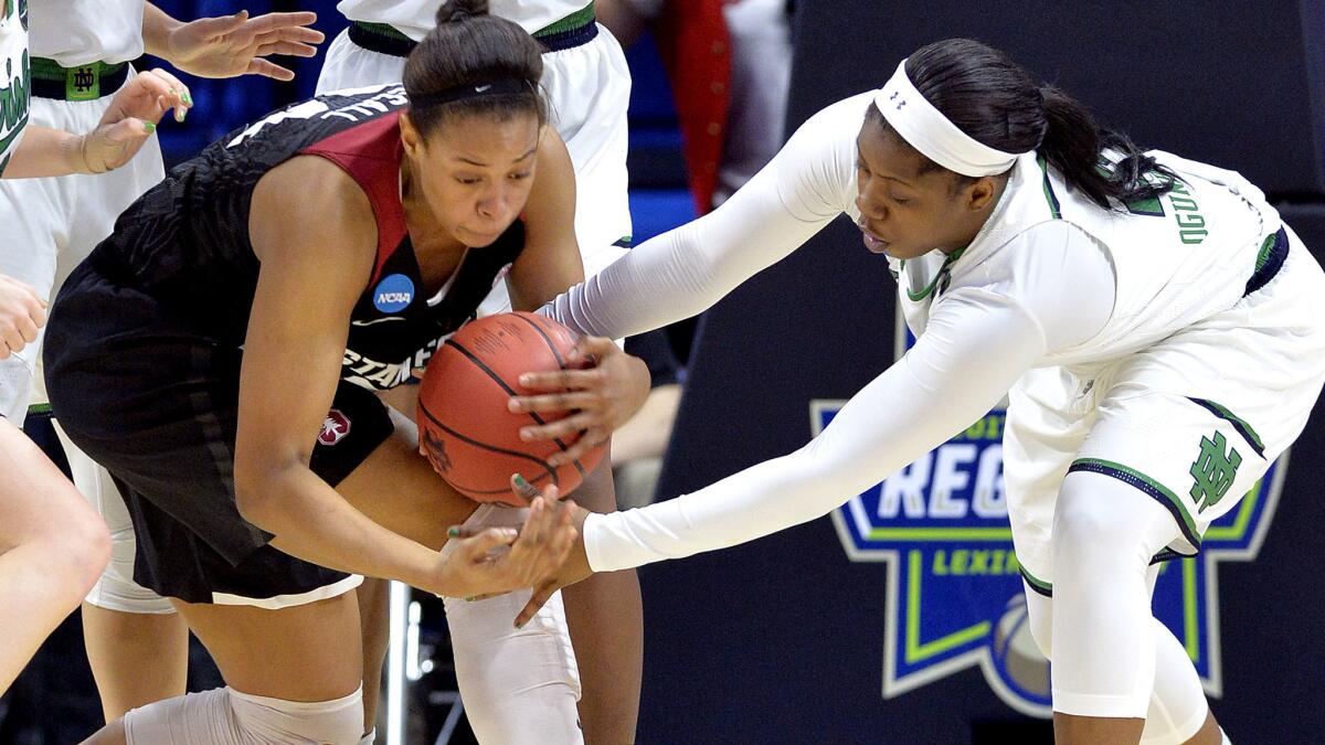 Stanford's Erica McCall, left, battles Notre Dame's Arike Ogunbowale for a loose ball during the second half Sunday. (Timothy D. Easley / Associated Press)