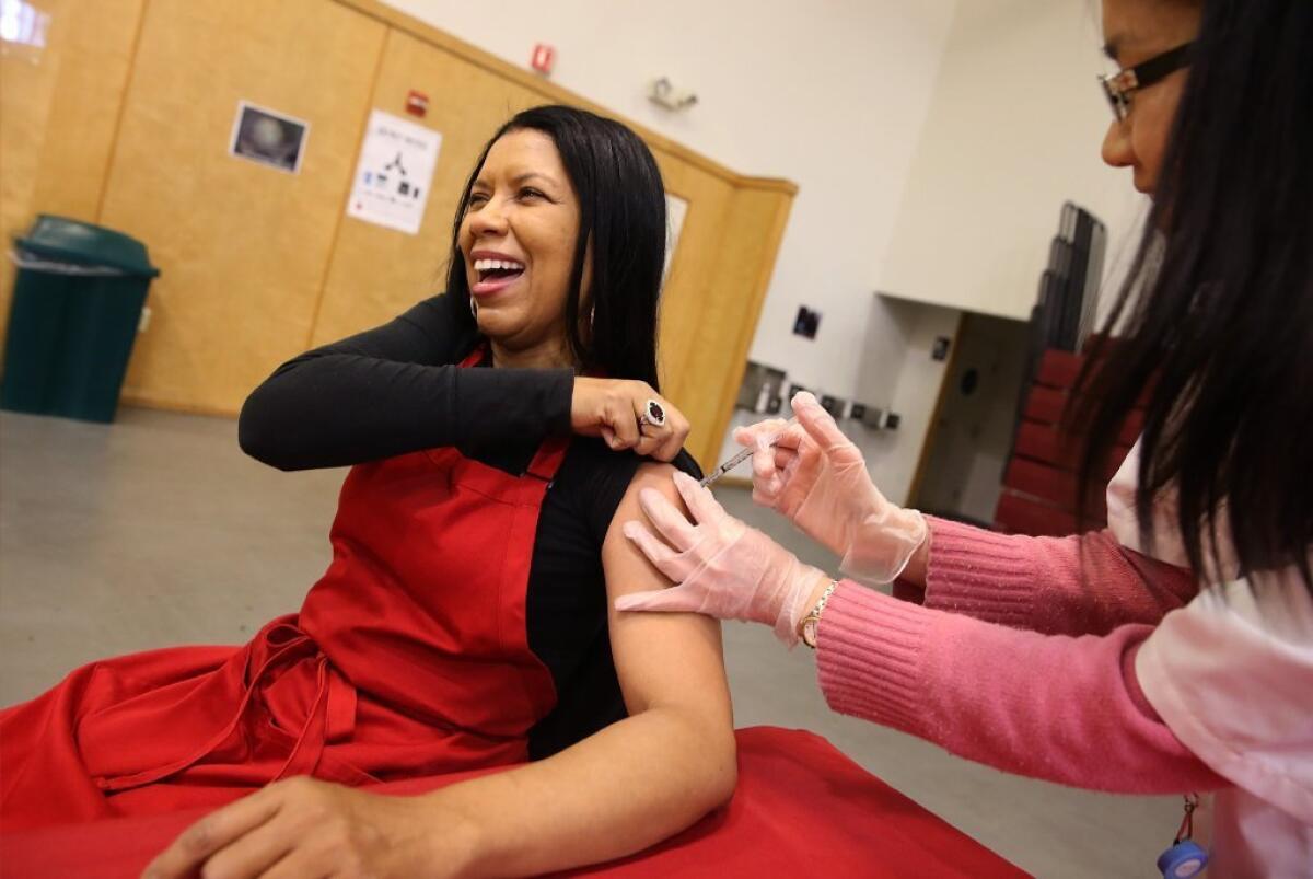 Cynthia Foreman receives a free flu shot in Oakland last month. By the end of December, flu activity was "widespread" in 43 states, according to the CDC.