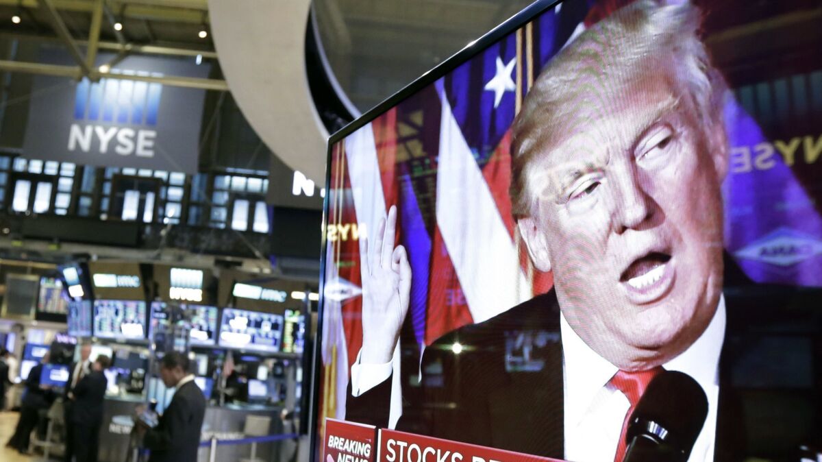 An image of Donald Trump appears on a television screen on the floor of the New York Stock Exchange on Nov. 9, 2016.