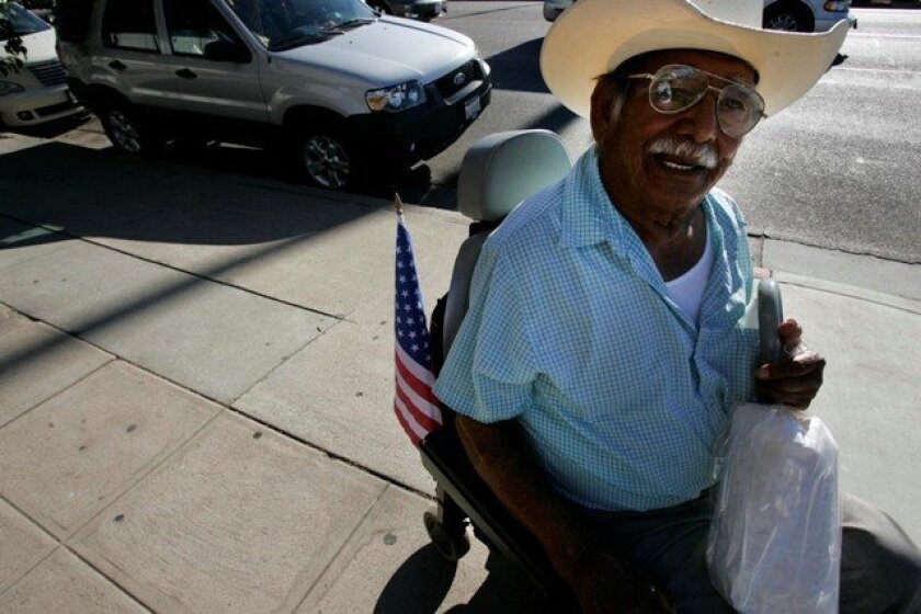 Reyes Banderas, who displays American and Mexican flags on his wheelchair, came to Escondido 40 years ago and ultimately gained his U.S. citizenship in 1990.