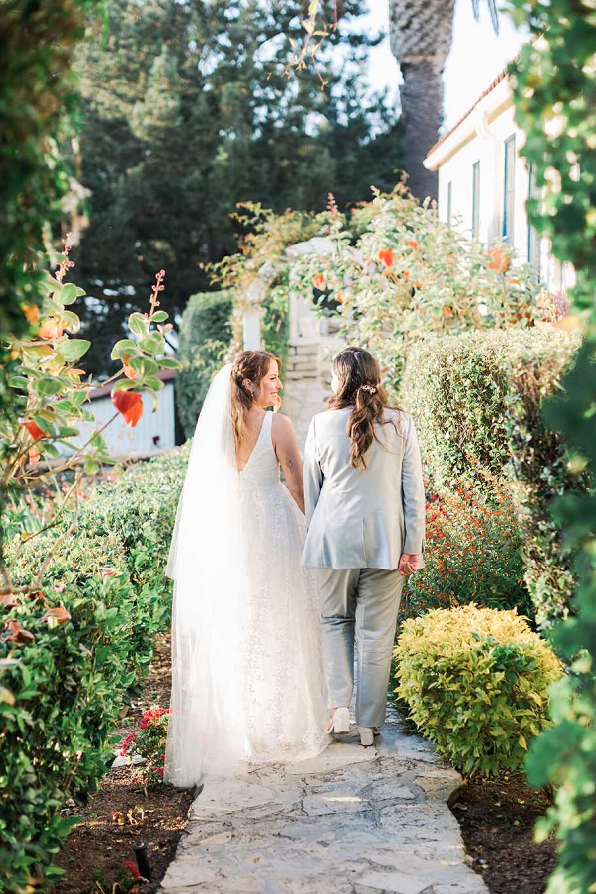 Newly married brides stroll through the gardens at La Venta Inn.