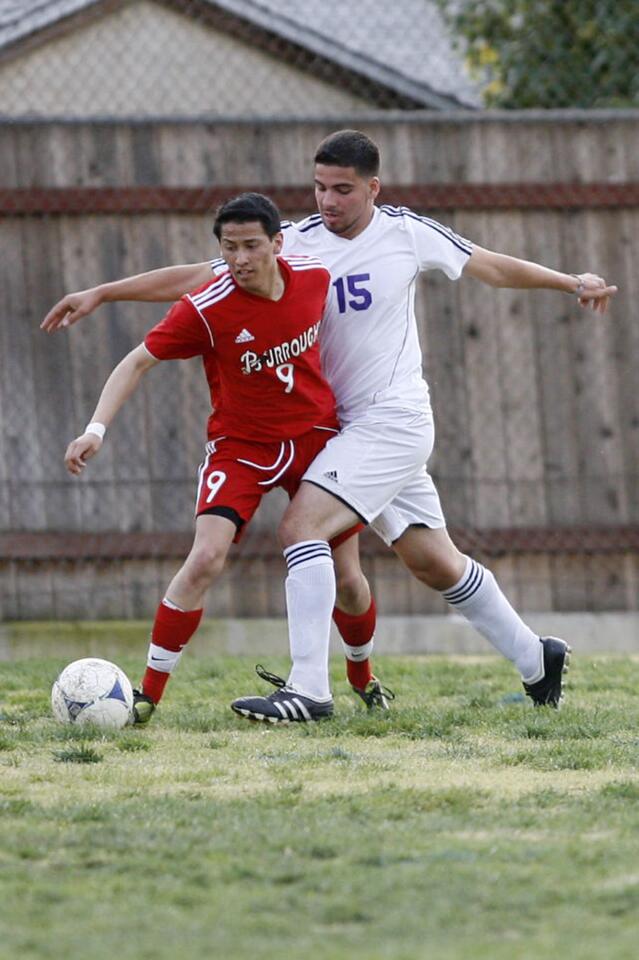 Burroughs' Nolberto Alcantar, left, and Hoover's Shadi Abdeldi fight for the ball during a game at Toll Middle School in Glendale on Tuesday, January 22, 2013.