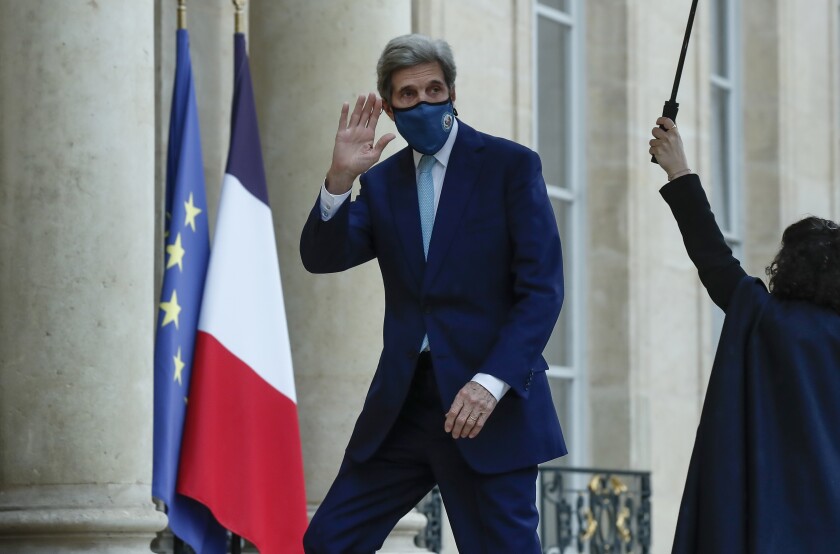 United States Special Presidential Envoy for Climate John Kerry waves as he arrives at the Elysee Palace in Paris, Wednesday, March 10, 2021, to meet French President Emanjuel Macron. Kerry traveled to Paris to relaunch transatlantic cooperation with European officials in the wake of President Joe Biden's decision to rejoin the global effort to curb climate change. (AP Photo/Michel Euler)