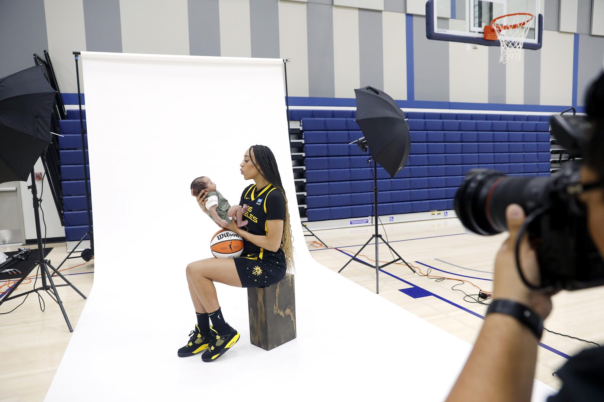 Sparks forward Dearica Hamby takes photos with her 8-week-old son Legend during 2023 media day at El Camino College.
