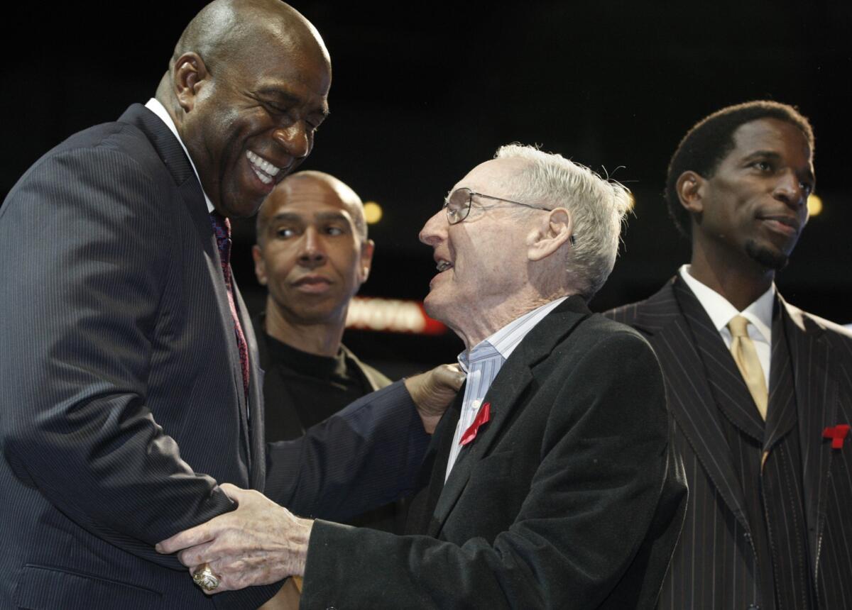 Former Lakers Coach Bill Sharman, right, is greeted by Lakers great Magic Johnson during a news conference in 2011. Sharman, who coached the Lakers to the 1972 NBA title, is still finding ways to make an impact in people's lives at the age of 87.