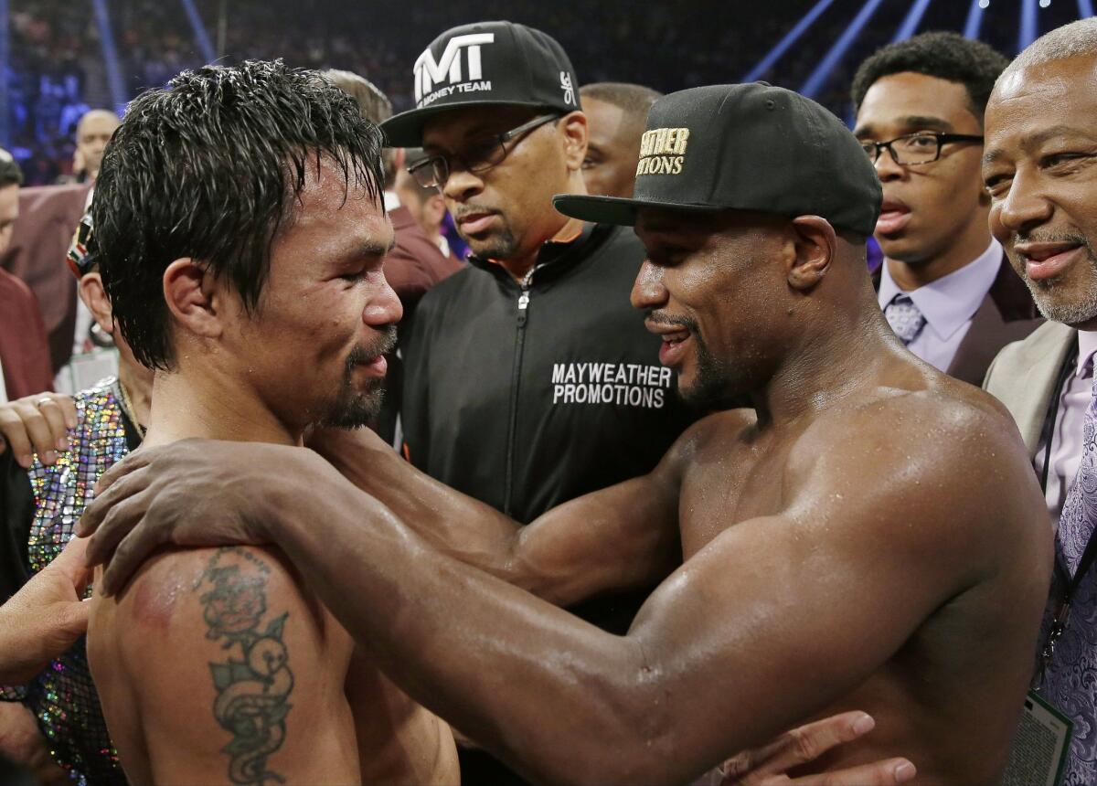 Manny Pacquiao, left, and Floyd Mayweather Jr. embrace in the ring after their May 2 welterweight title fight in Las Vegas that brought them both millions of dollars.