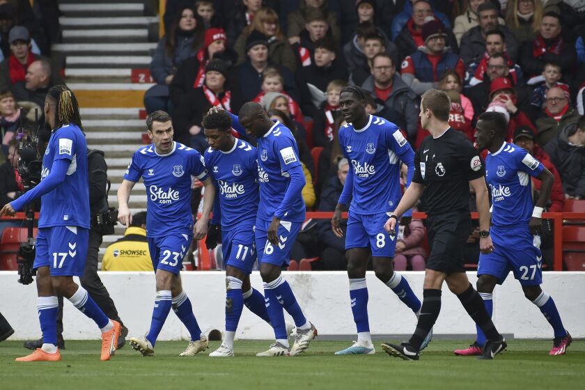Everton's Demarai Gray, (11), celebrates with teammates after scoring the opening goal from the penalty spot during the English Premier League soccer match between Nottingham Forest and Everton at The City Ground in Nottingham, England, Sunday, March 5, 2023. (AP Photo/Rui Vieira)