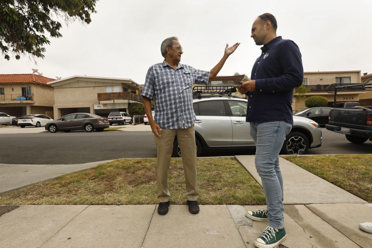 City Council candidate Jimmy Biblarz, right, speaks to voter Adolfo Vallejo.