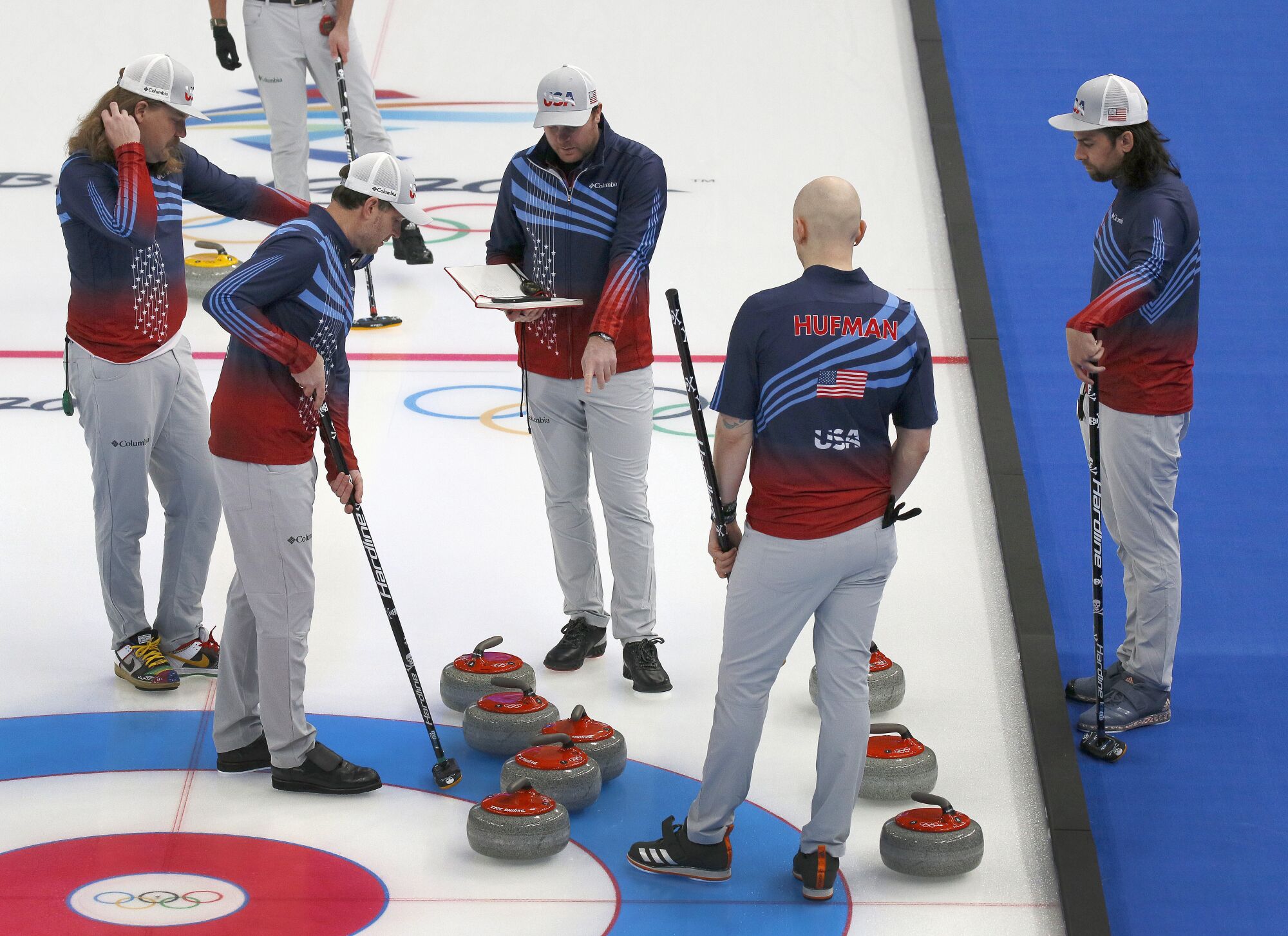 U.S. curling coach Sean Beighton speaks to his team during practice.