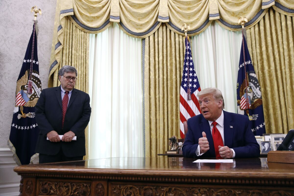President Donald Trump speaks alongside Attorney General William Barr.