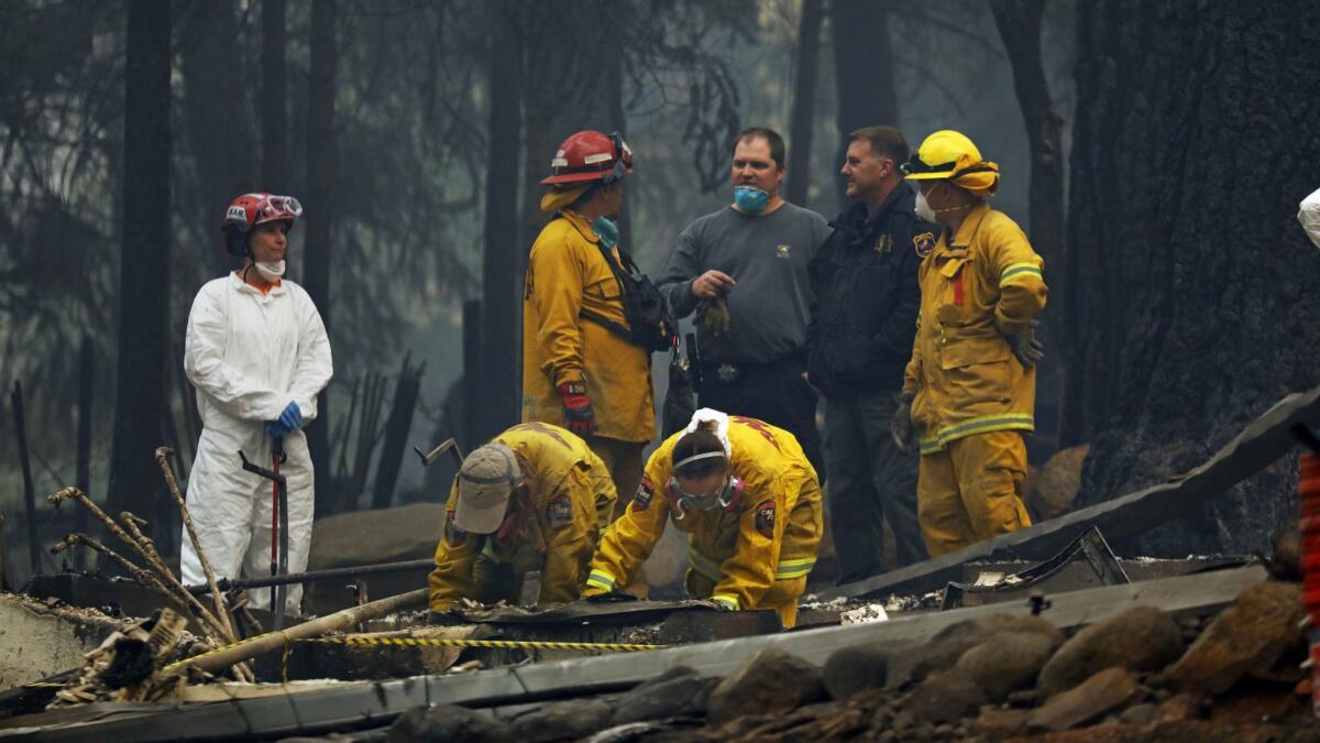 A forensic team investigates the site of a home where remains were found from the Camp fire in Paradise.