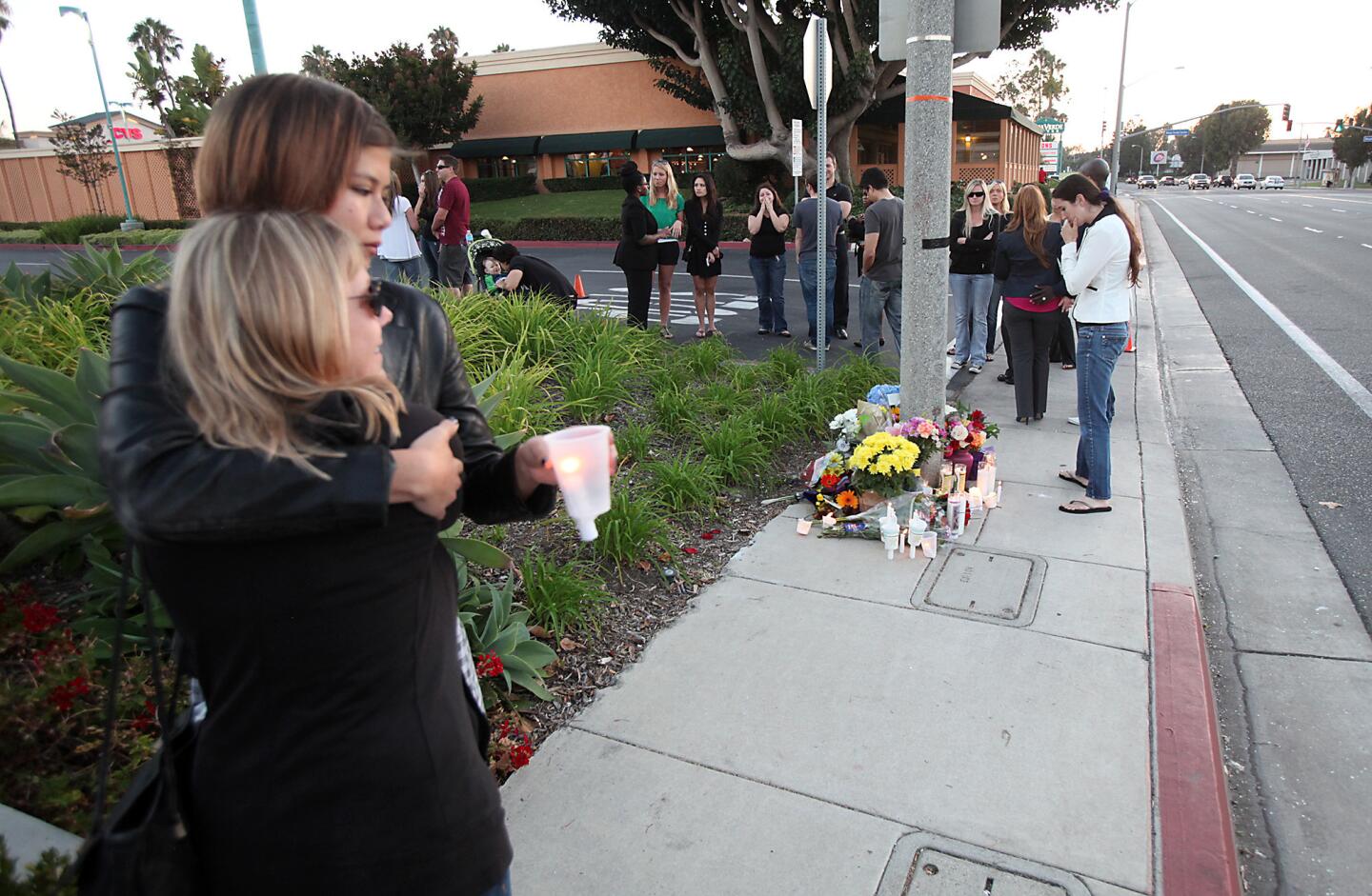 Friends and family gather to remember Chad deLorm with a candlelight vigil Monday at the location where he crashed his motorcycle into a Honda Civic on Adams Avenue in Costa Mesa.