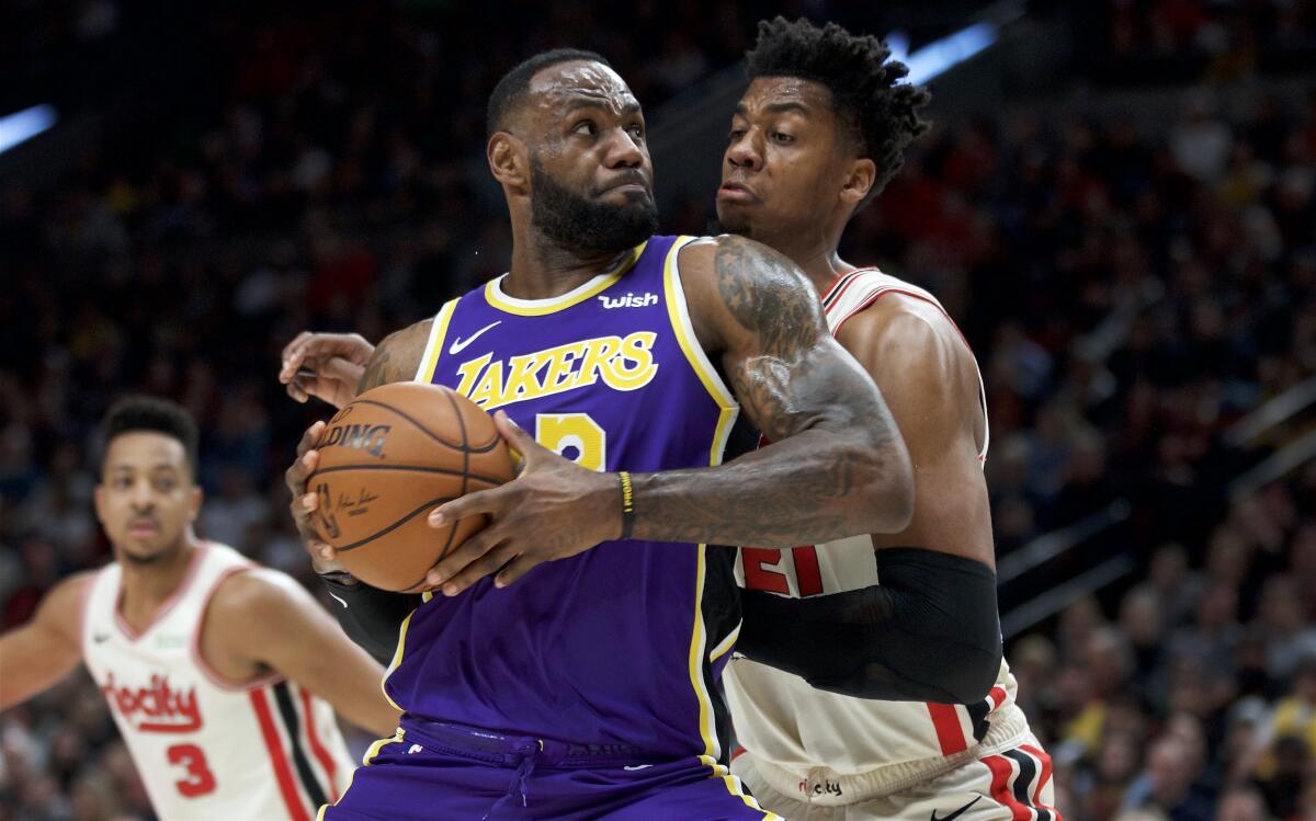 The Lakers' LeBron James battles the Trail Blazers' Hassan Whiteside on Dec. 28, 2019.