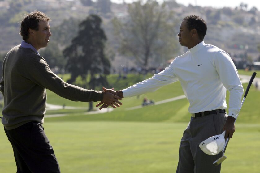 FILE - Tiger Woods, right, shakes hands with Stephen Ames after Woods' 9 and 8 victory in the first round of the World Match Play Golf Championship, Wednesday Feb. 22, 2006, in Carlsbad, Calif. That remains the Match Play record for largest margin of victory. (AP Photo/Chris Carlson, File)