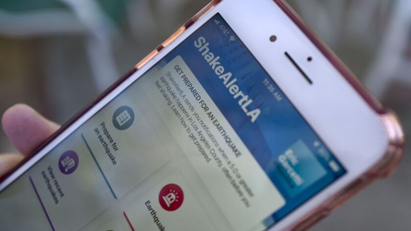 A user opens ShakeAlertLA, an earthquake warning application, on their phone in Los Angeles on Jan. 3.