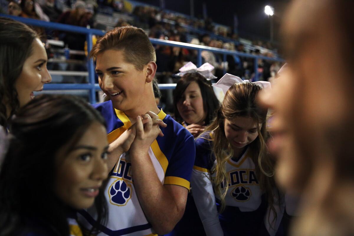 Jeb Burke, center left, is the only male cheerleader on the Taft Union High School squad on November 1, 2019, in Taft, California.